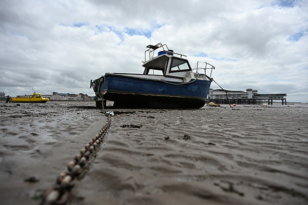 Low-ange shot of chain leading up to boat